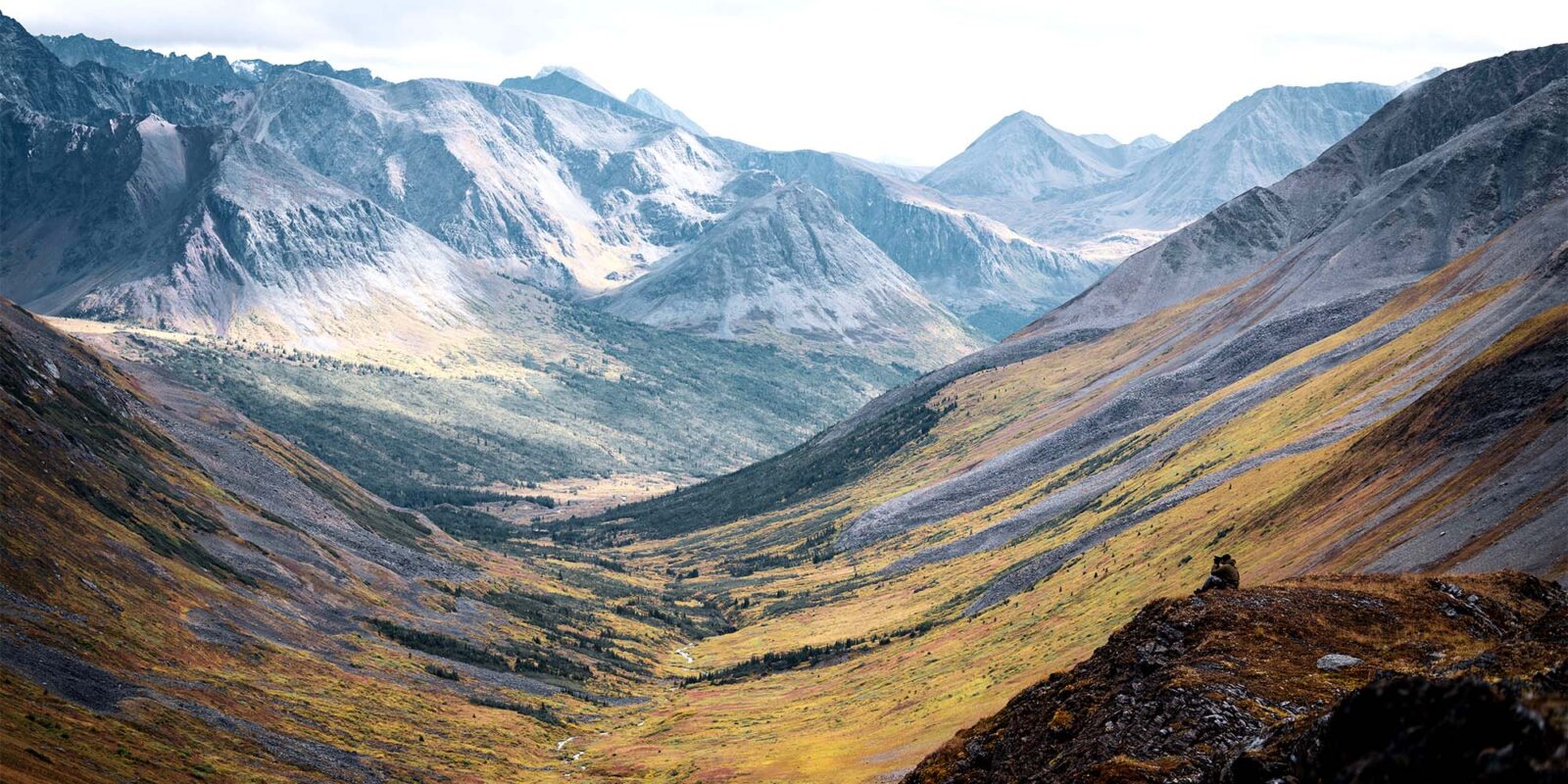 Hunter glassing into a mountain valley