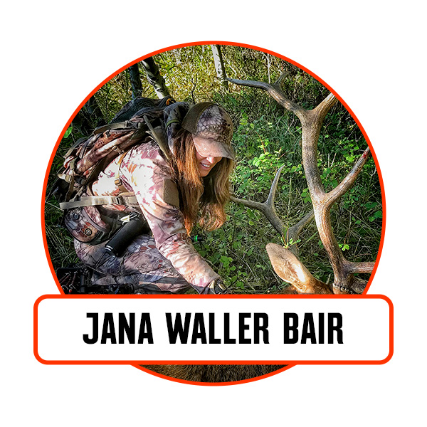 A woman with the bull elk she harvested.