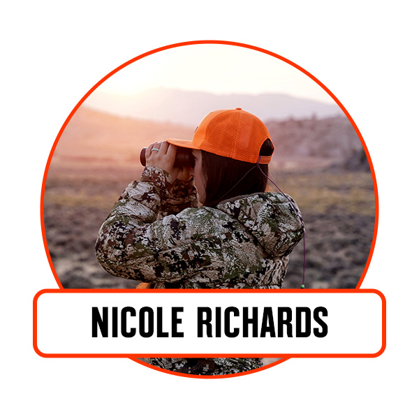 A woman glassing in an a blaze orange hat.