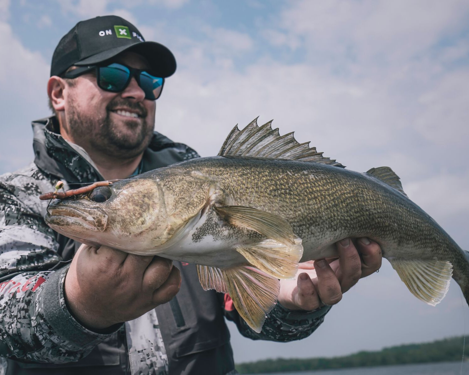An angler holds a big walleye.