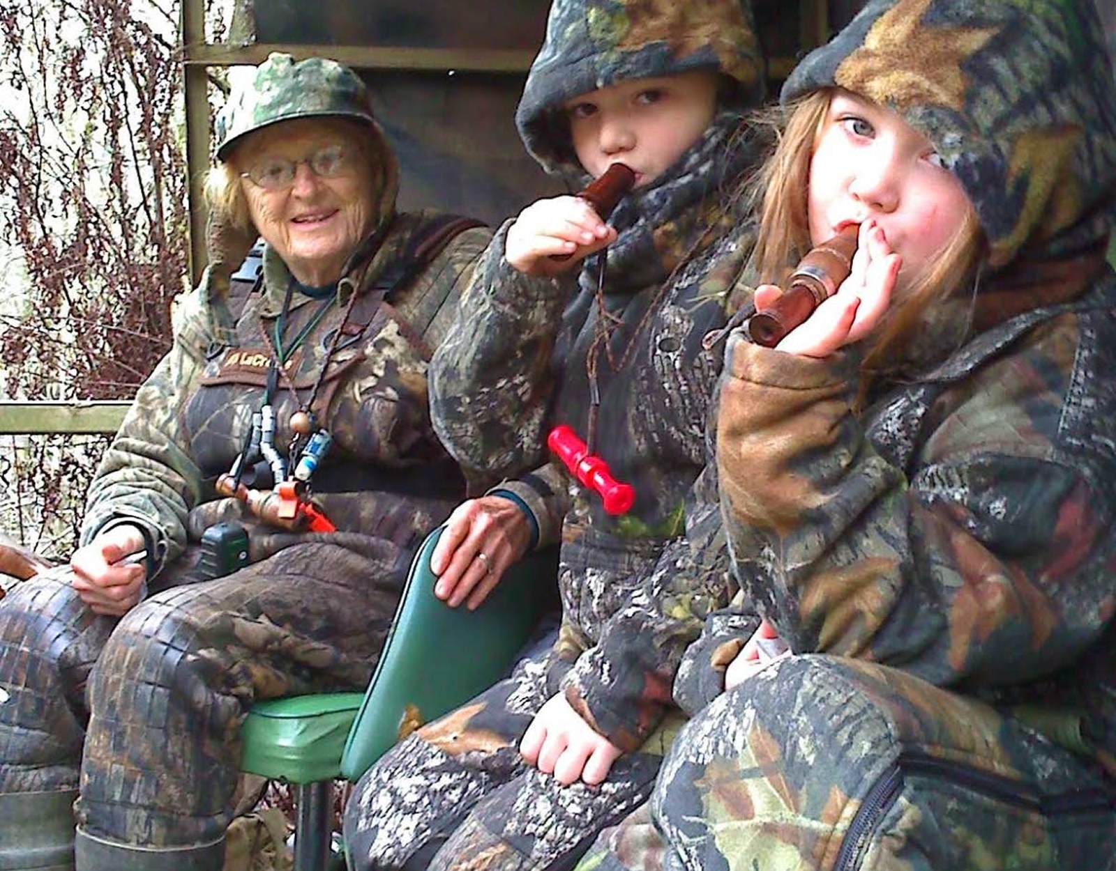 A group of people in camo in a duck blind.
