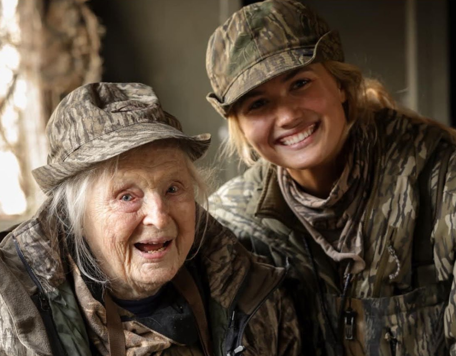 A group of people in camo in a duck blind.