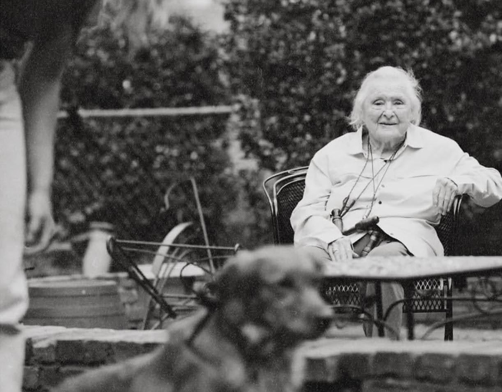 A woman watches a dog and its handler.