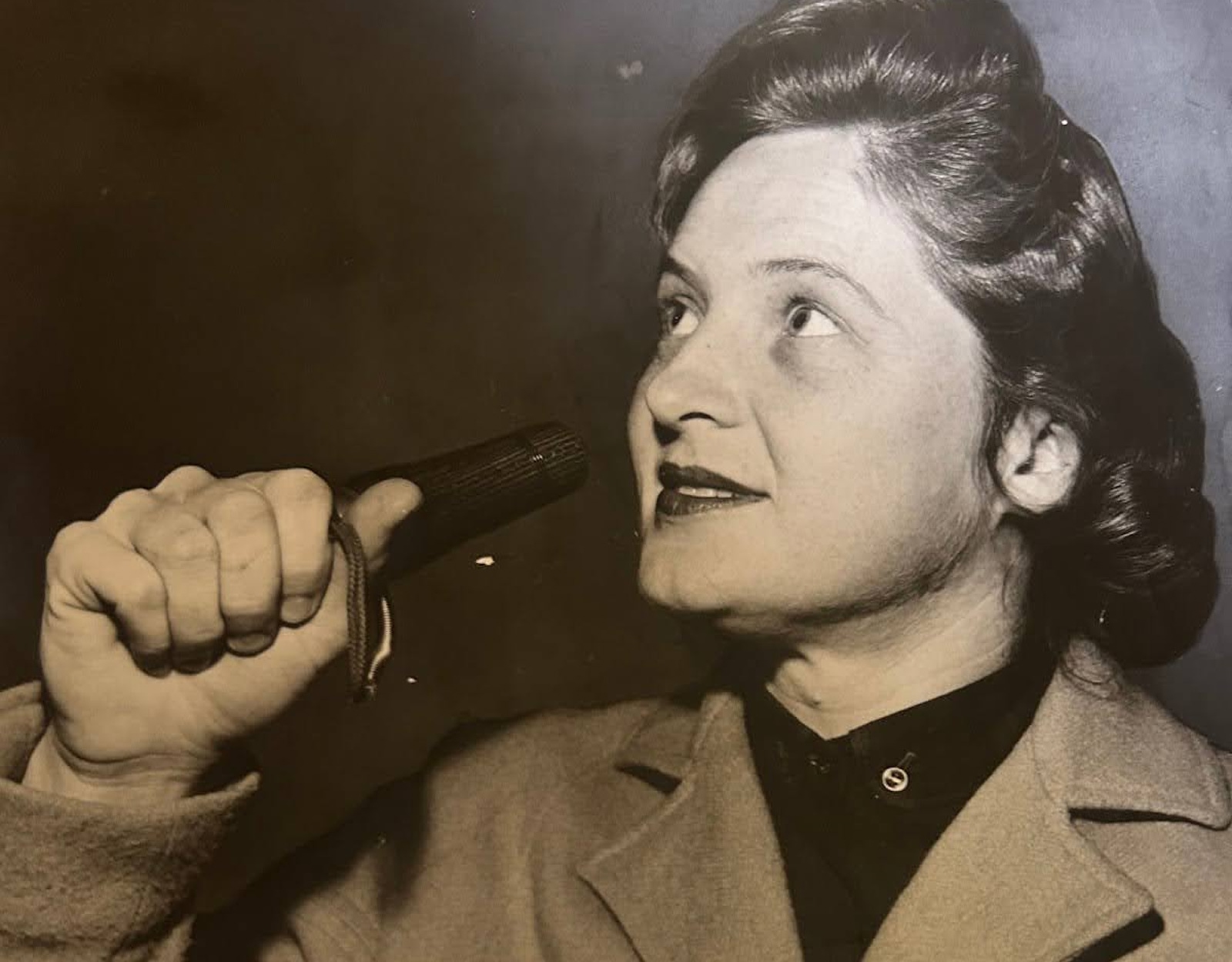 Gail Camp holds a duck call in her hand.