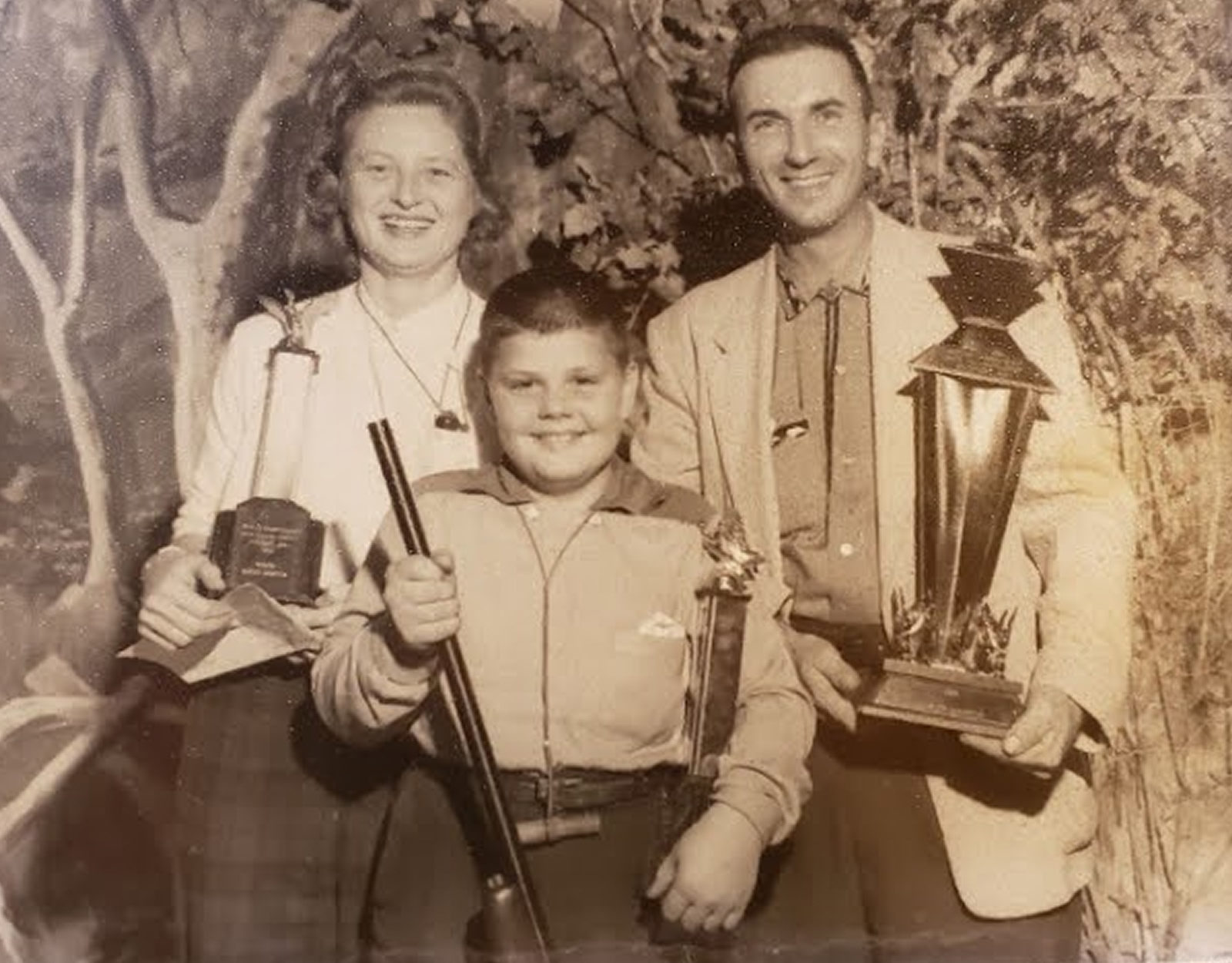 Black and white image of people posing with trophies.