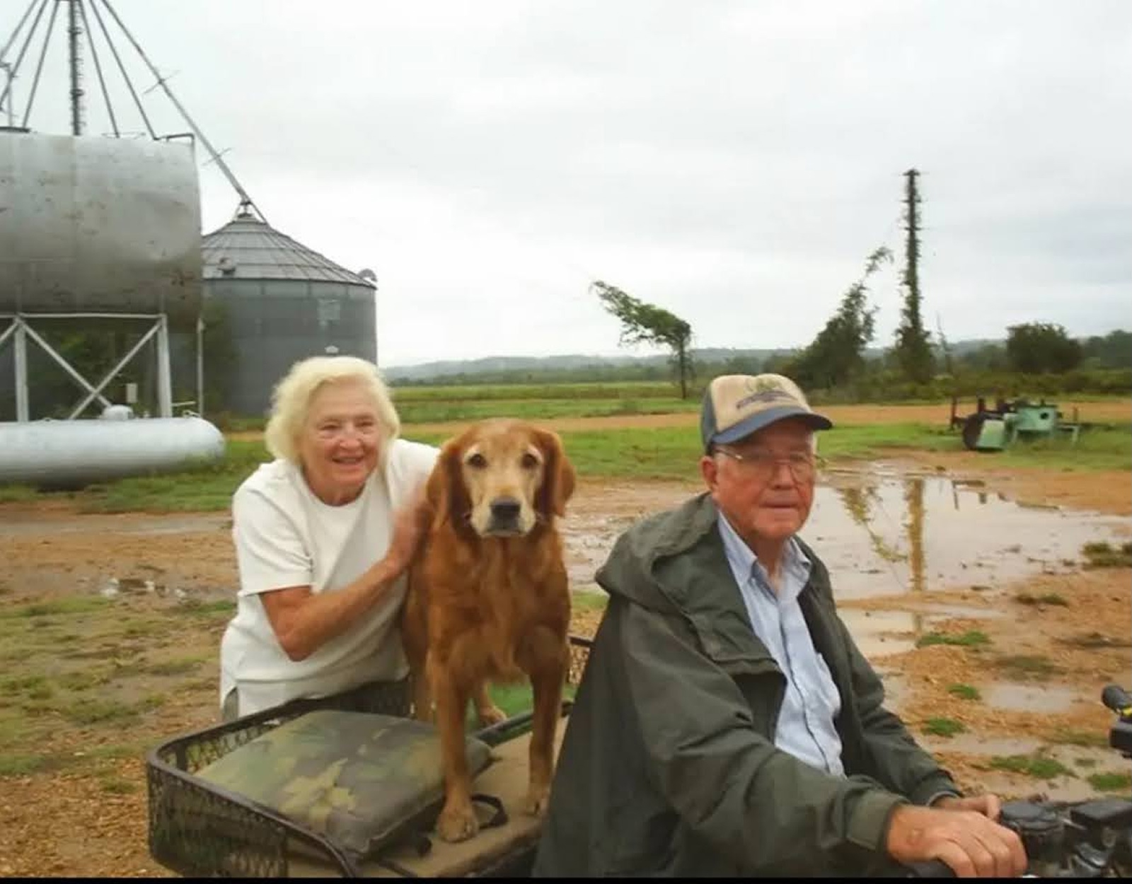 A man and woman and their golden retriever.