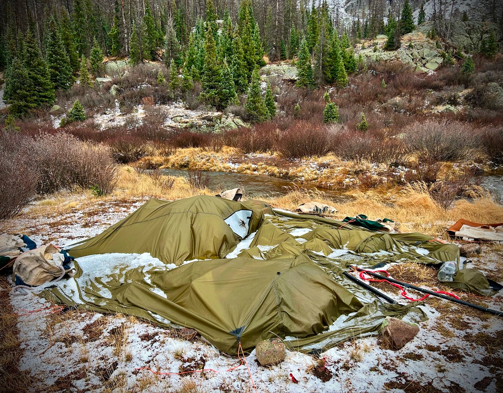 A tent is flattened in the backcountry.