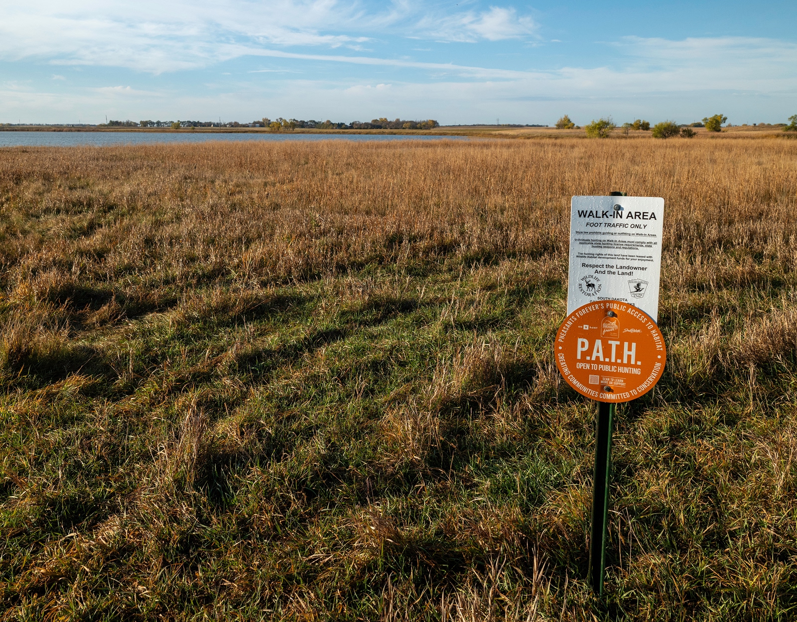 A prairie with a sign that reads P.A.T.H.