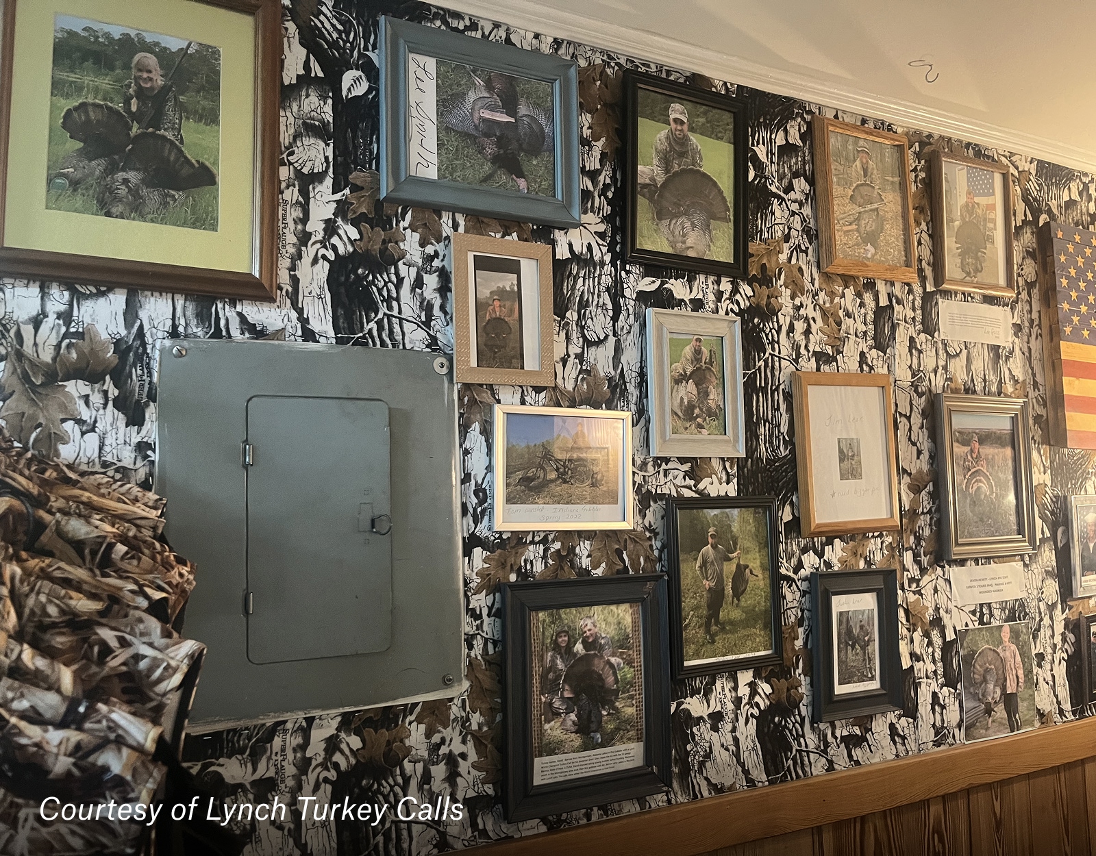 Numerous framed photos hang on a wall.