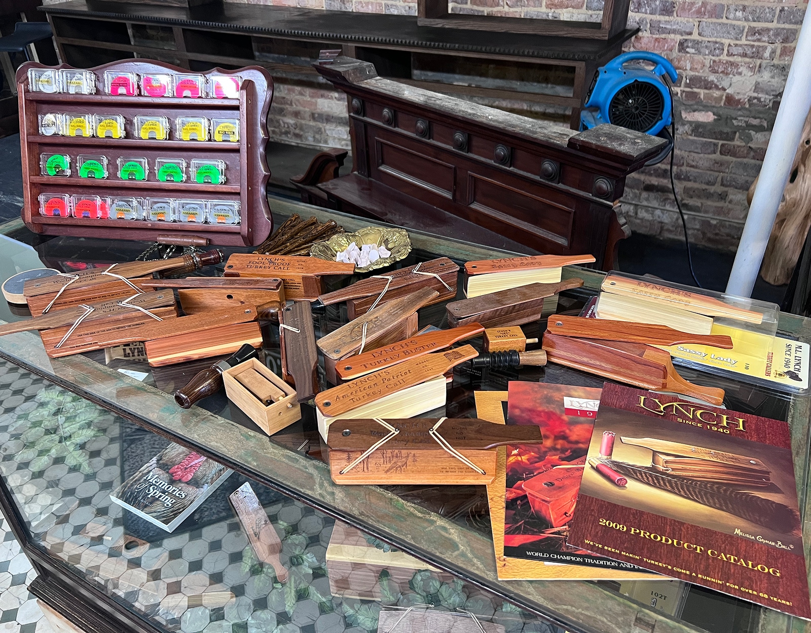 ML lynch turkey calls on a glass case.