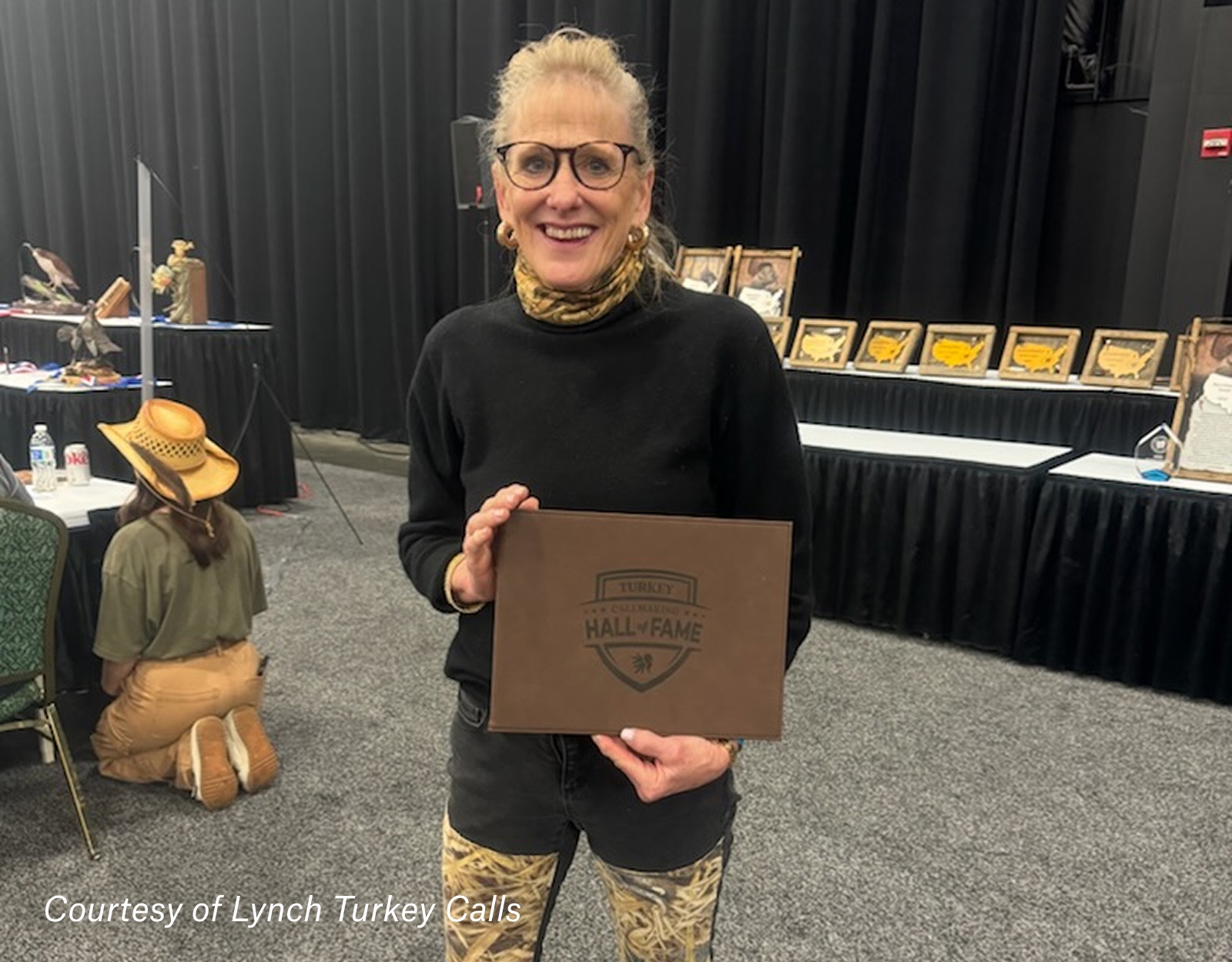 Johanna Gaines, president of ML Lynch Turkey Calls, accepts a Hall of Fame placard at NWTF.