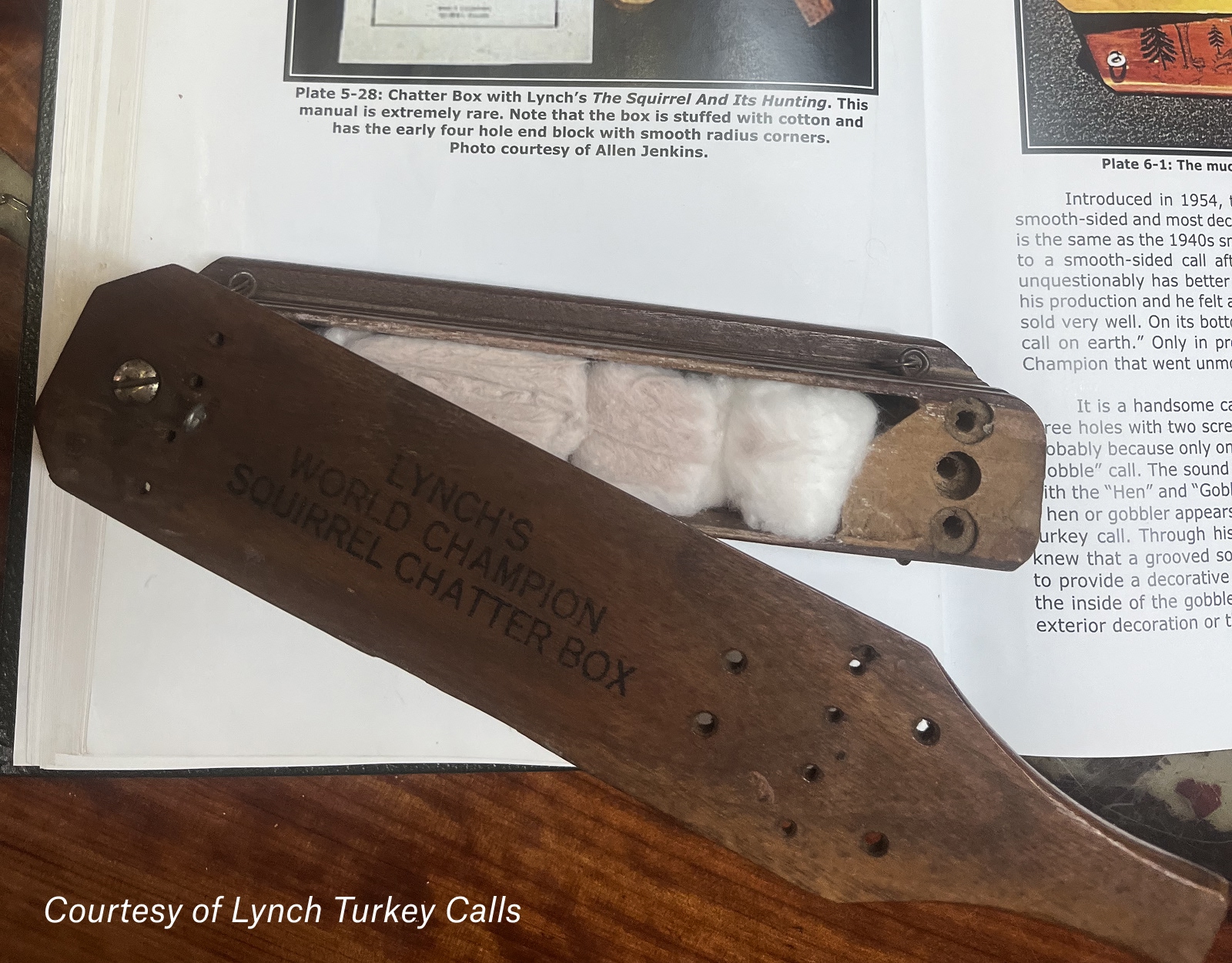 An antique squirrel call filled with cotton balls.