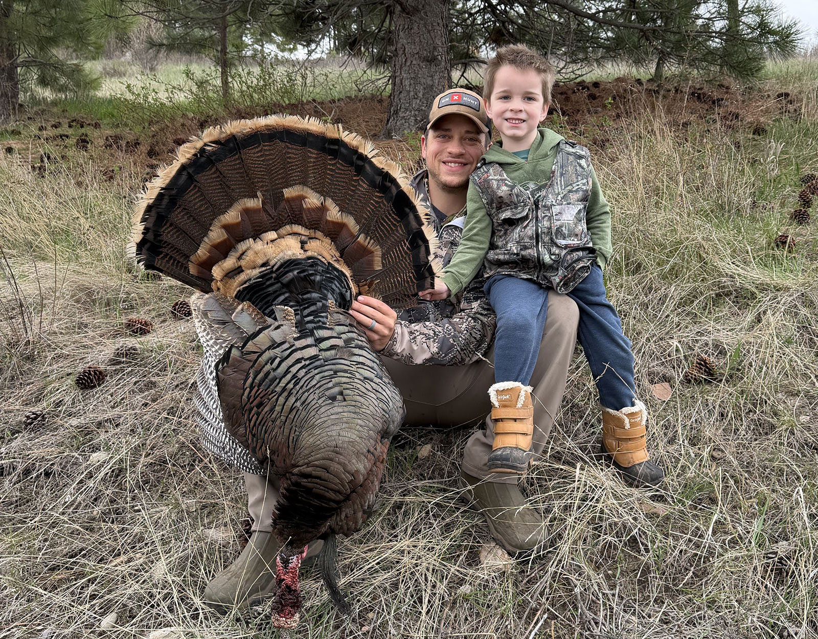 A father and son turkey hunting together