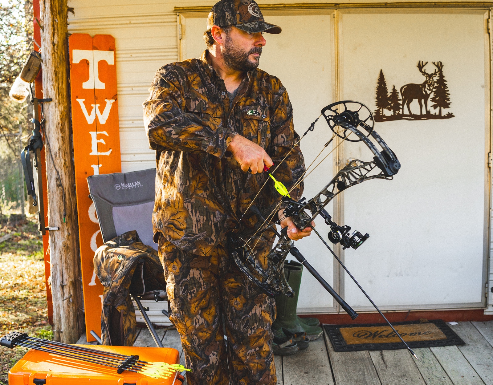 A man prepares to draw back his compound bow.