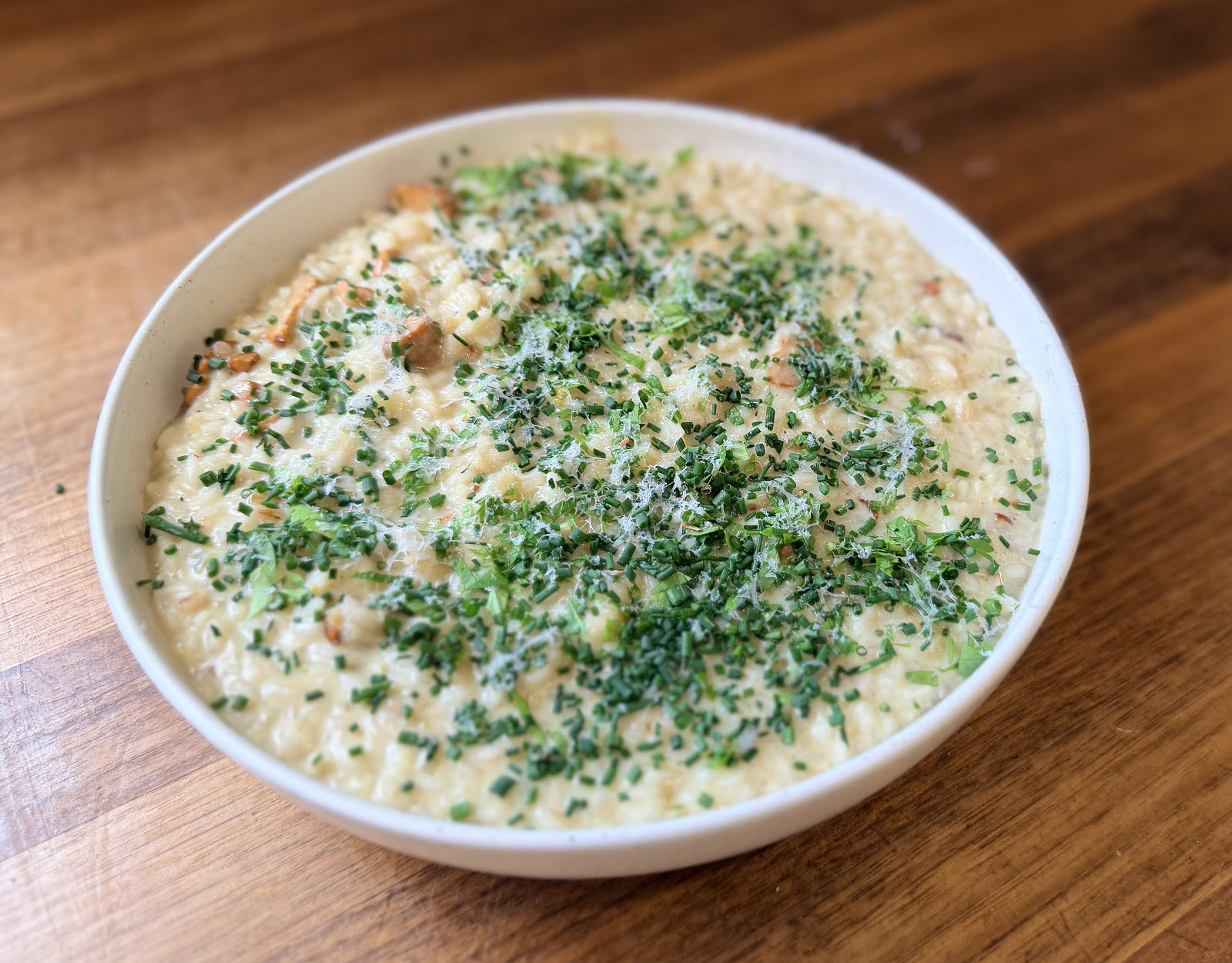 Chanterelle risotto plated in a white bowl