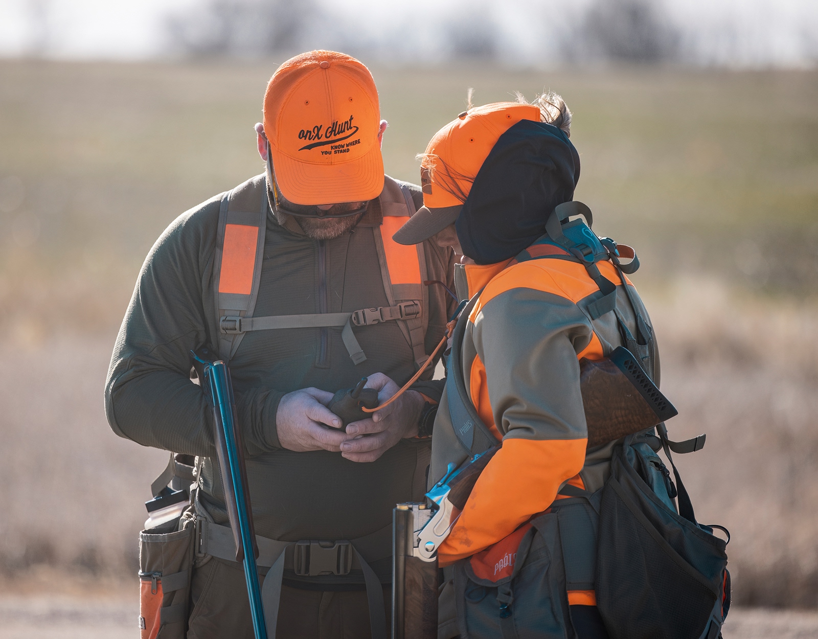 Two hunters and Blaze Orange discuss their next step in the field.