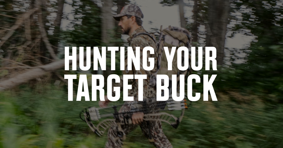 A hunter wearing camo, carrying his bow