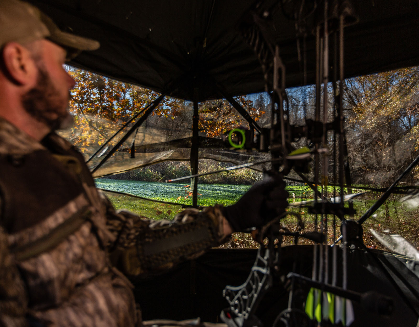A bowhunter in a deer blind.