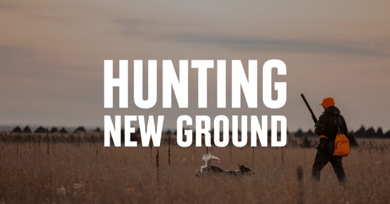 A woman upland hunter and her dog walk through the prairie, and "hunting new ground" is overlaid in white font.
