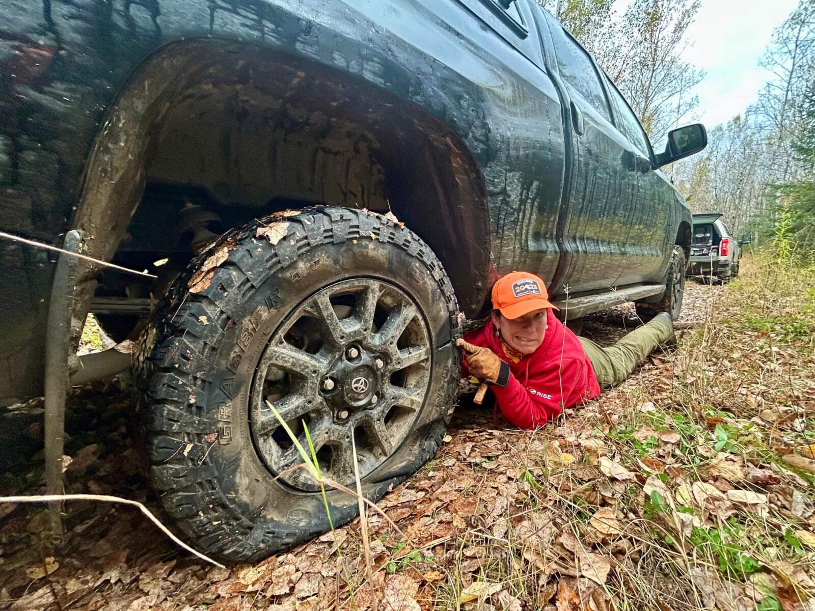 A woman fixes a flat tire.