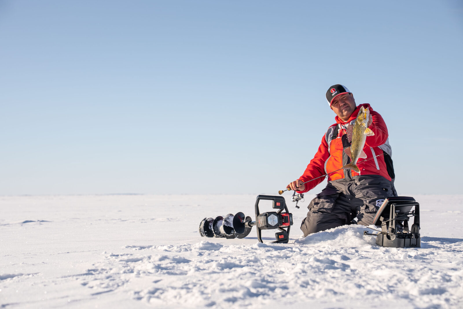 ice fishing angler with a walleye