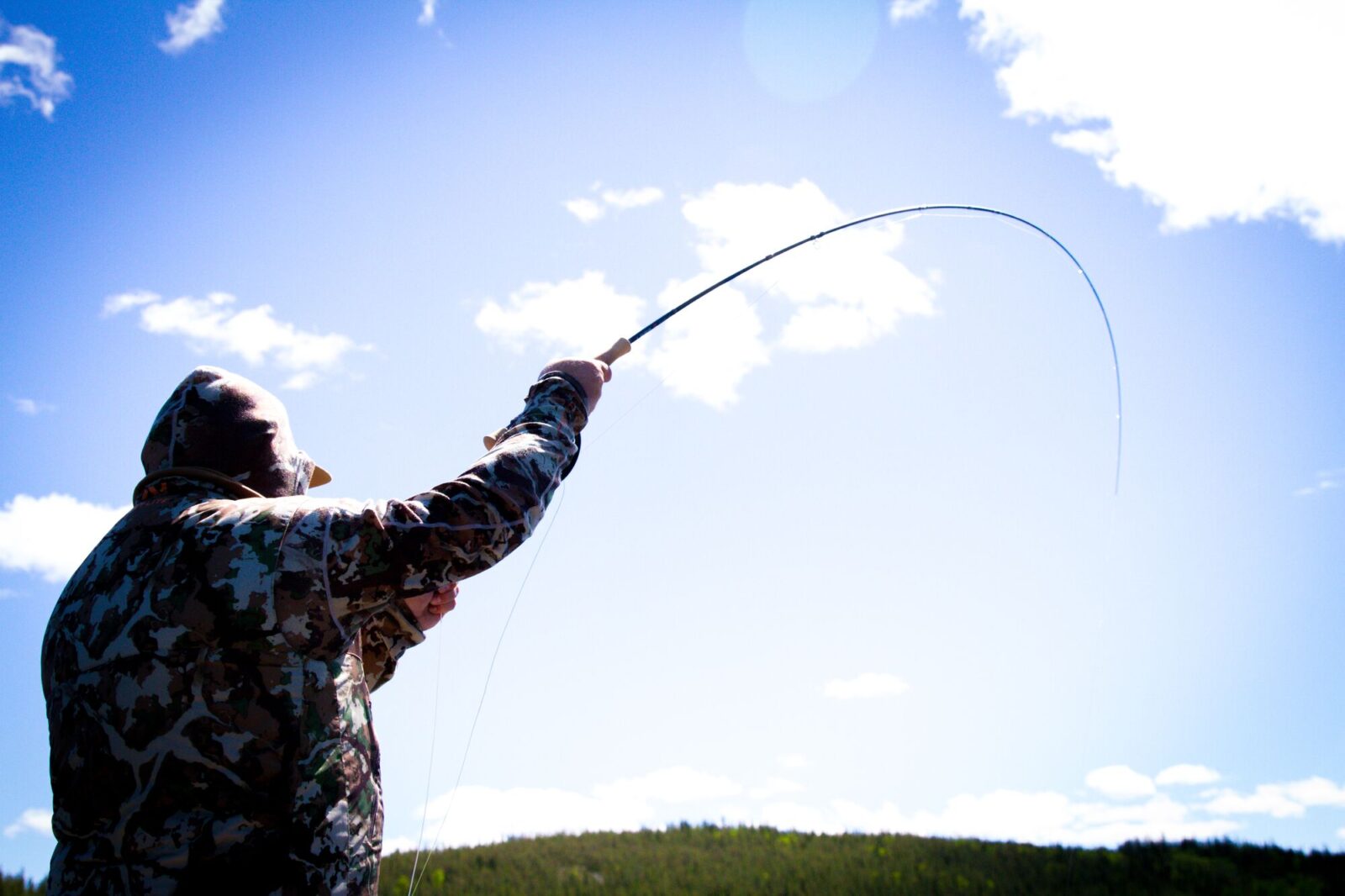 Man fishing on a clear, sunny day.