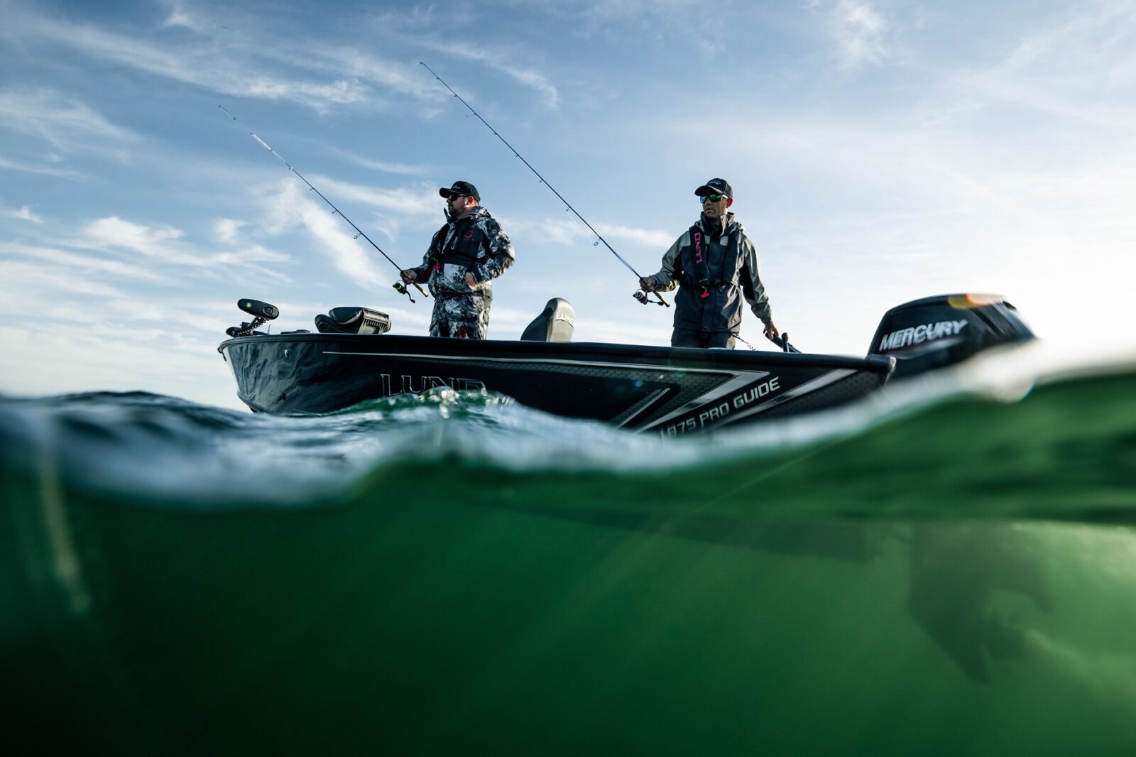 Two men fishing on a boat.