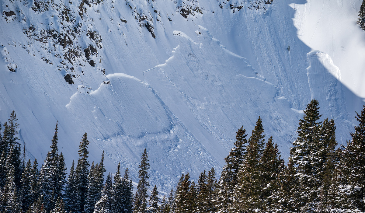 Avalanche being triggered in the backcountry 