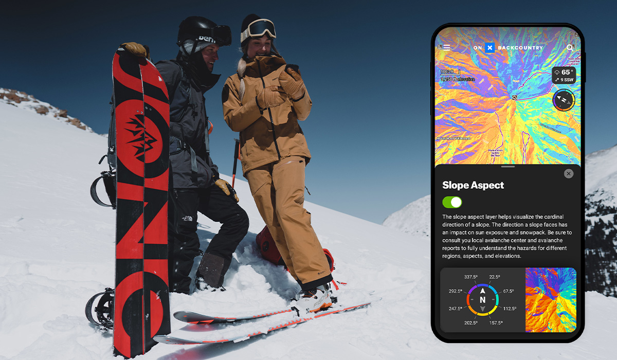 2 backcountry skiers looking at the onX Backcountry app and the slope aspect data on a phone screen screen. 