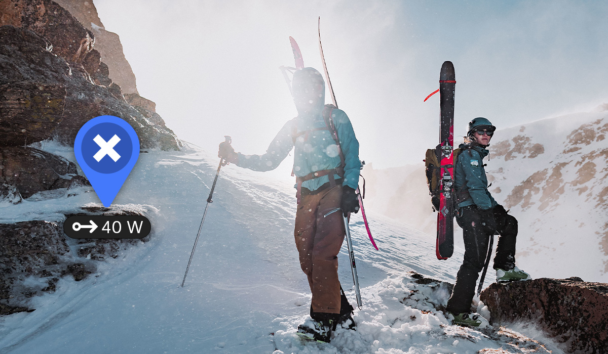 2 backcountry skiers on a mountain with an onX Backcountry logo showing the slope angle of the current slope. 