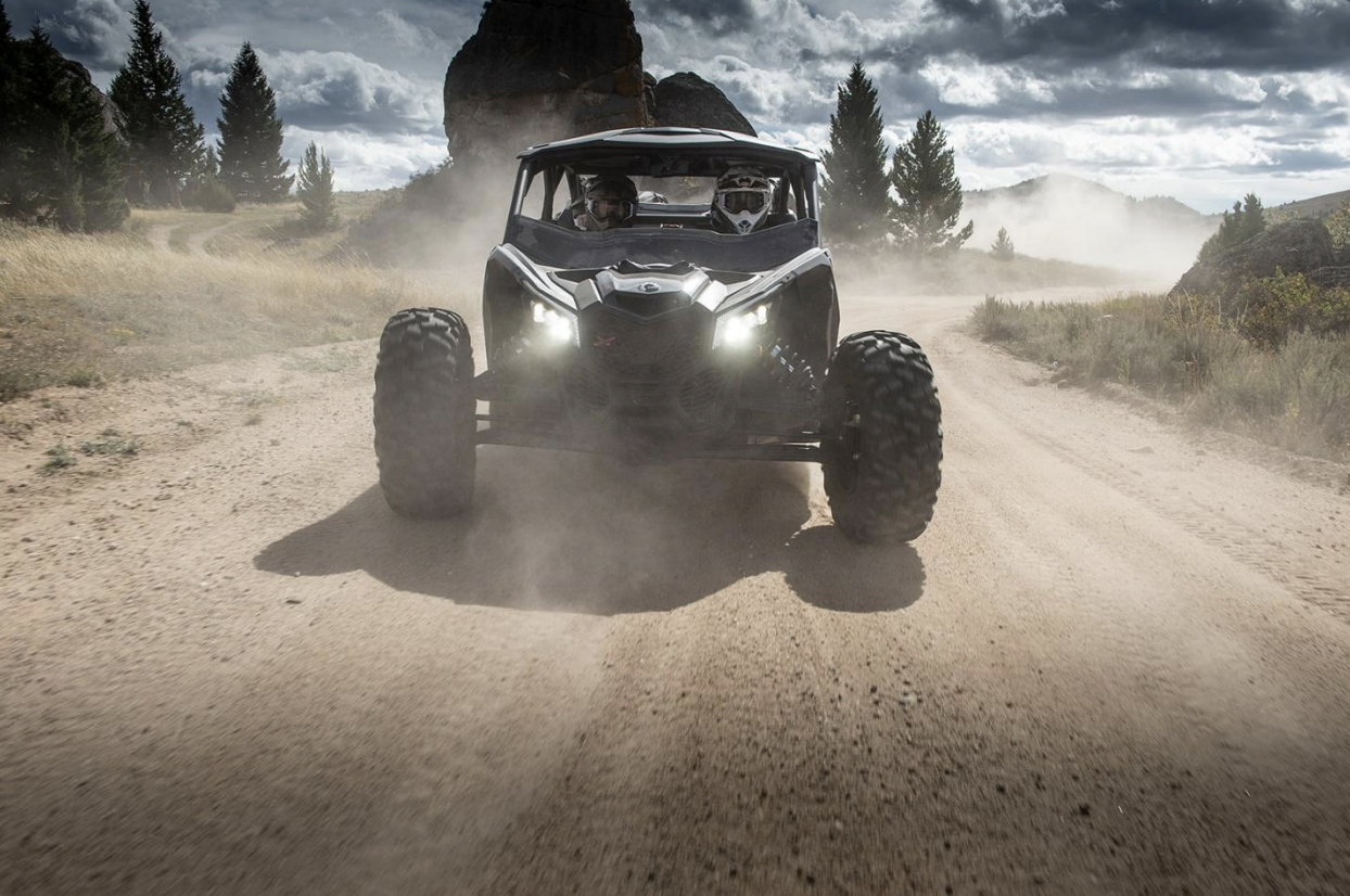 An electric side by side off-roading vehicle on a trail 