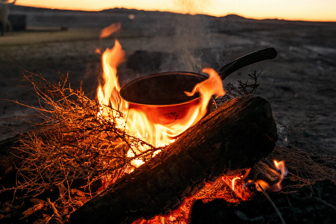 a campfire with camp cookware