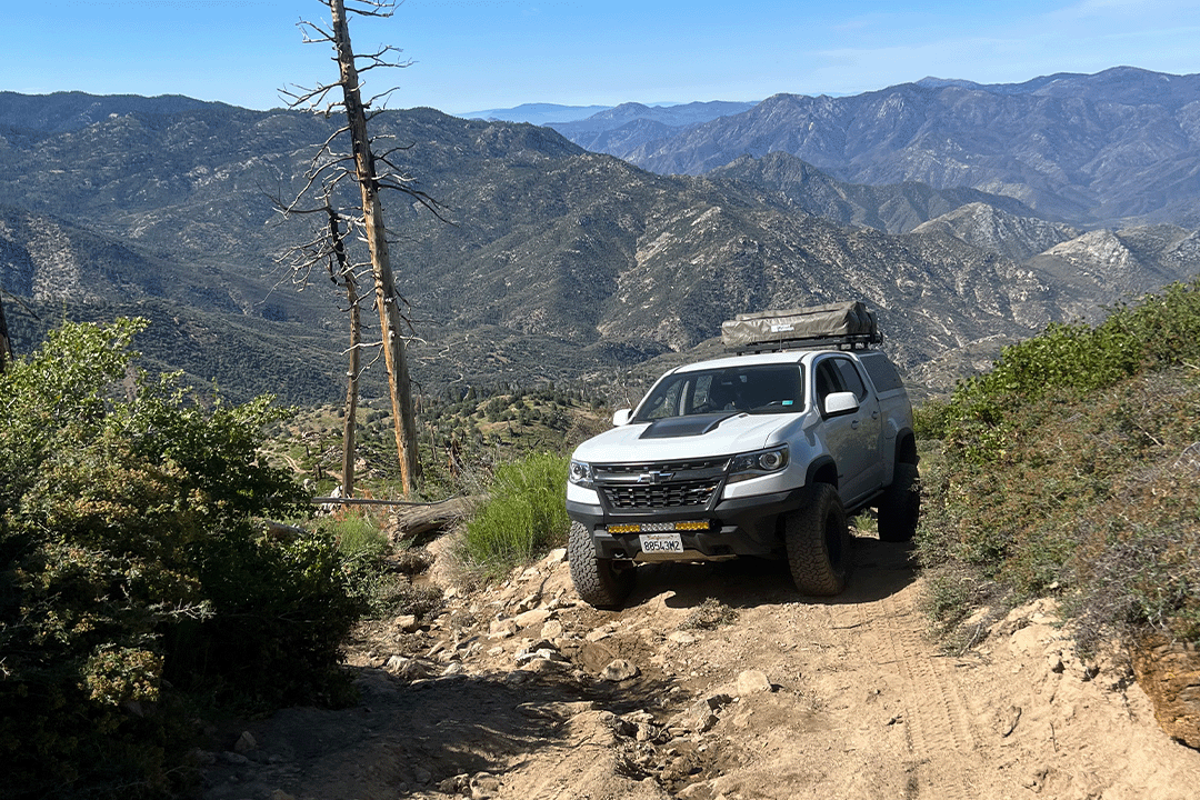 An off-road vehicle on a mountain ridge