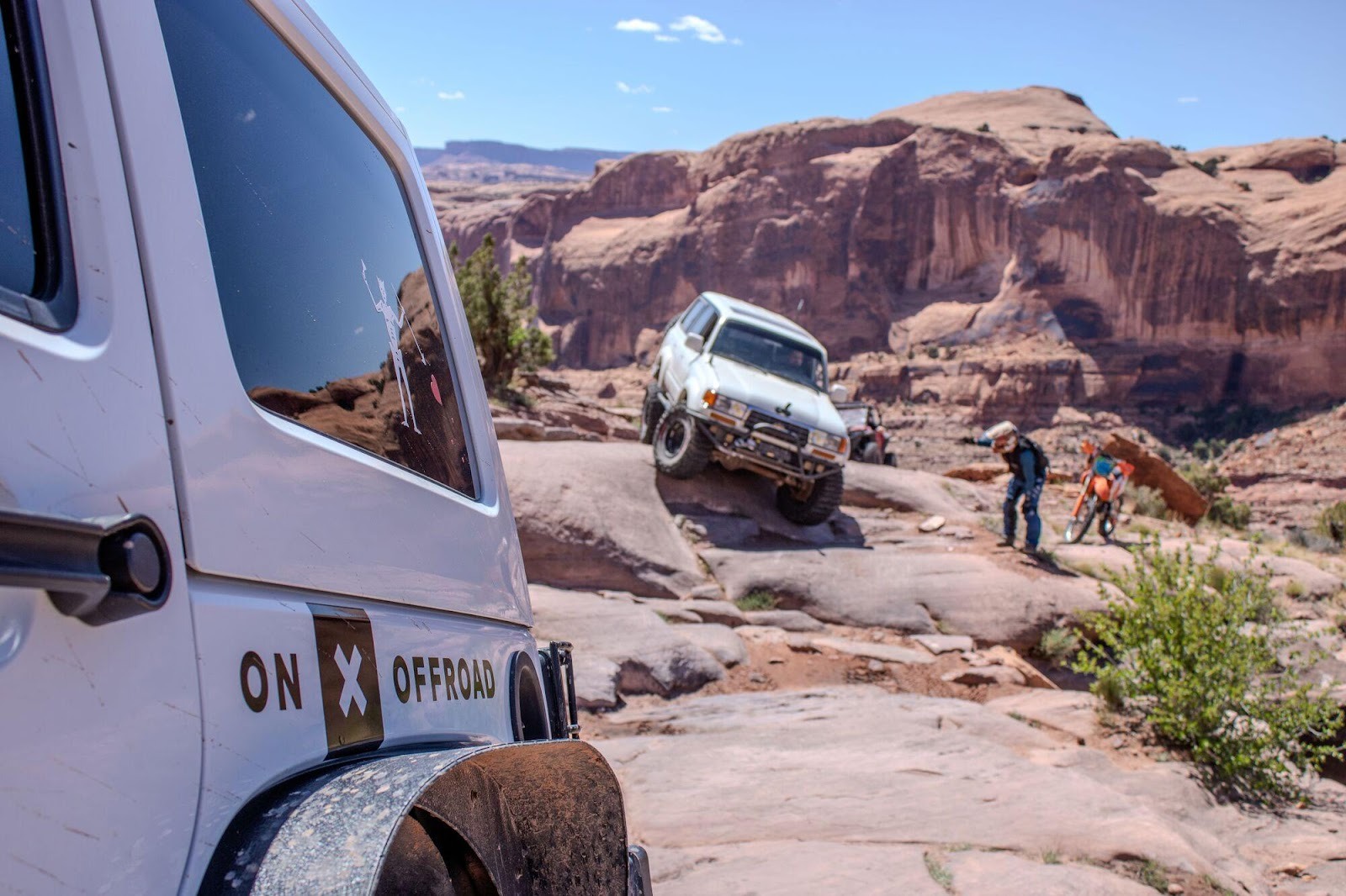off road vehicles crawling on a rocking trail 