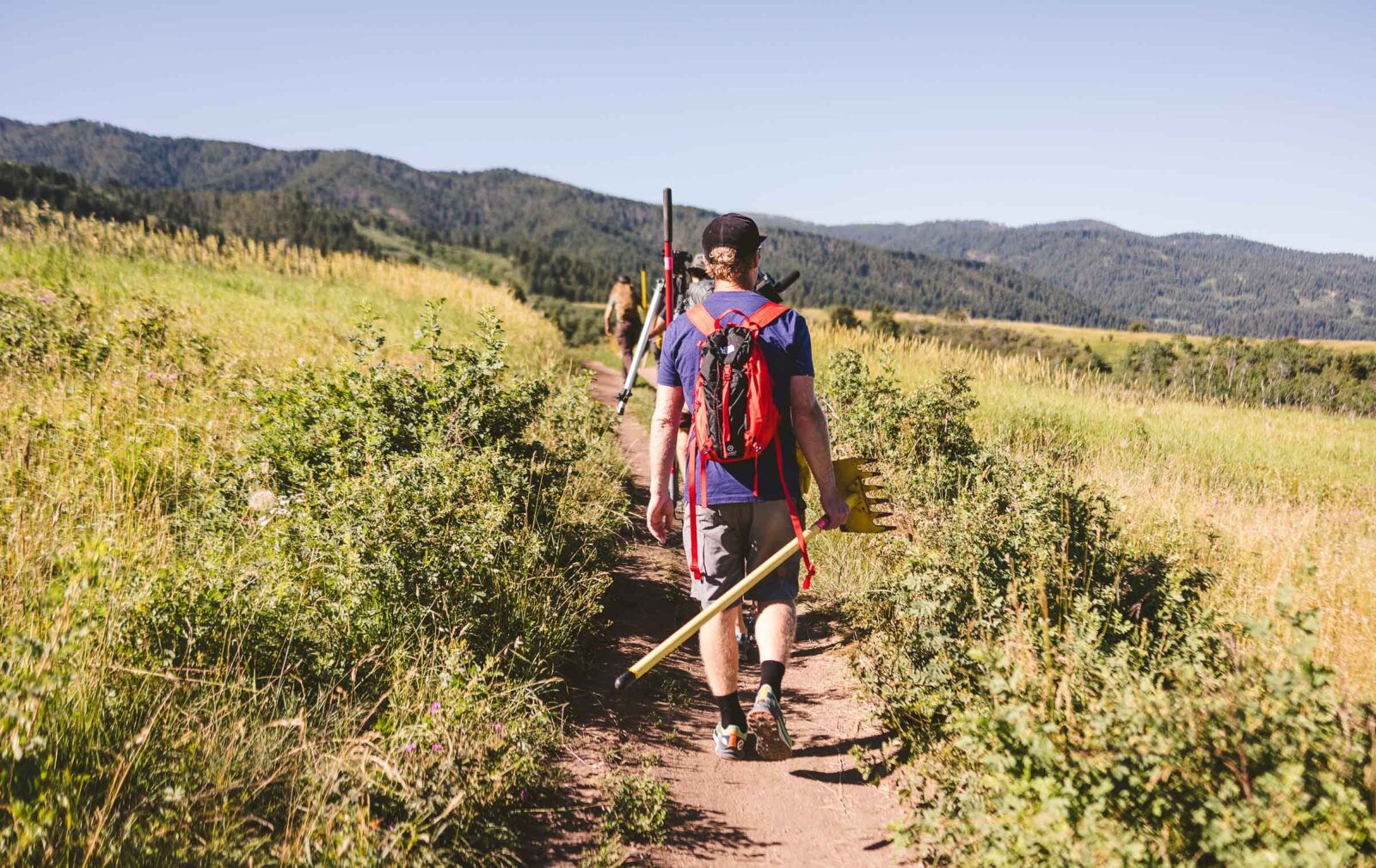 onX Offroad Trail Revival project volunteers walking up a dirt trail